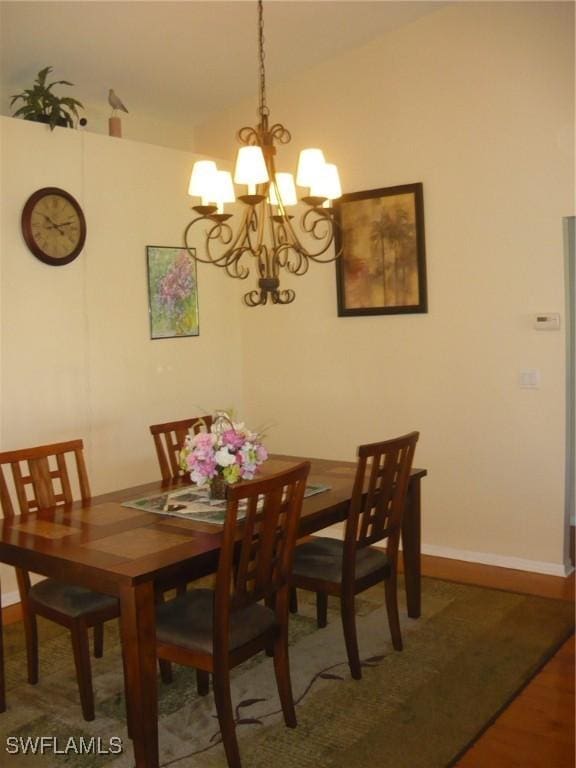 dining space with a notable chandelier and wood-type flooring