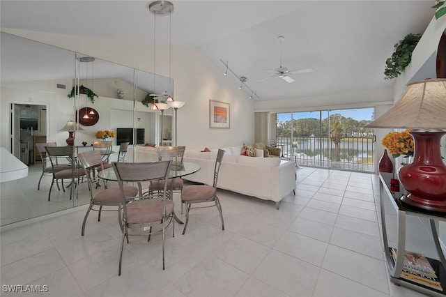 dining area featuring ceiling fan, high vaulted ceiling, light tile patterned floors, and visible vents