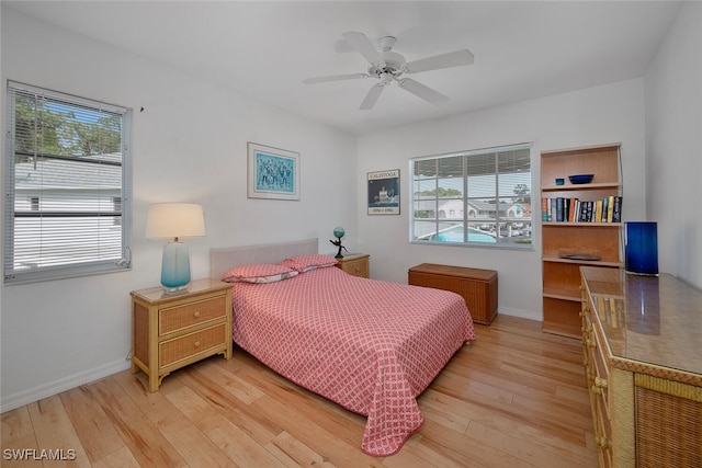 bedroom with light wood-type flooring and ceiling fan