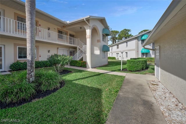 view of home's community featuring a lawn