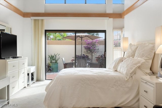 bedroom with access to exterior and light colored carpet