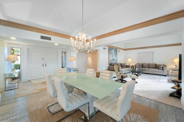 dining space with a notable chandelier and light wood-type flooring