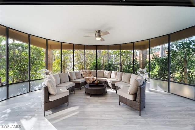 sunroom / solarium featuring ceiling fan