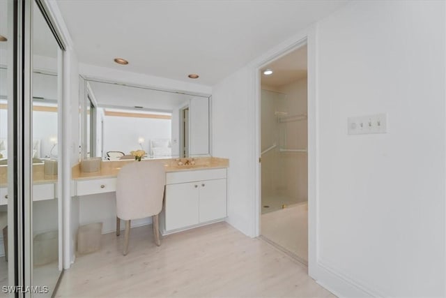 bathroom featuring vanity, hardwood / wood-style flooring, and walk in shower