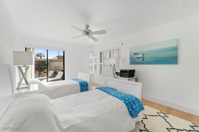 bedroom featuring hardwood / wood-style floors, ceiling fan, and access to outside