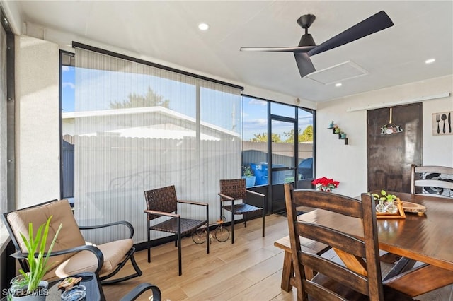 sunroom / solarium featuring ceiling fan