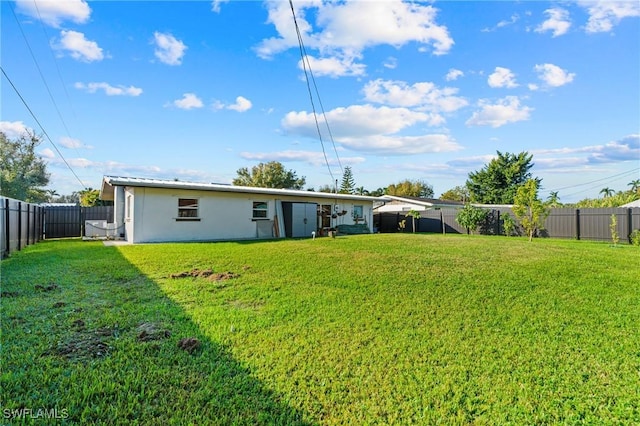 rear view of house featuring a yard