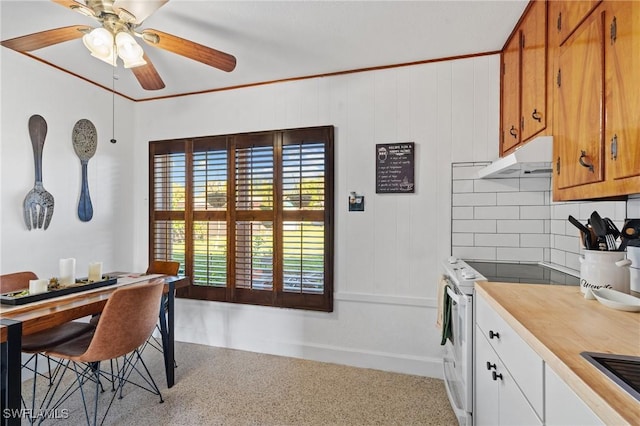 dining space with crown molding and ceiling fan