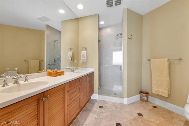 bathroom featuring tile patterned flooring, vanity, toilet, and walk in shower