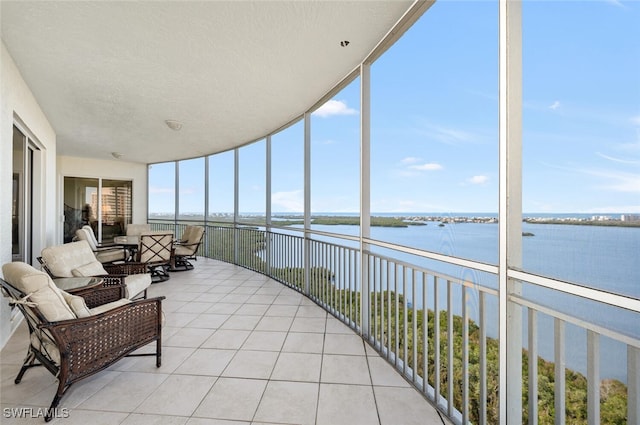 unfurnished sunroom with a water view