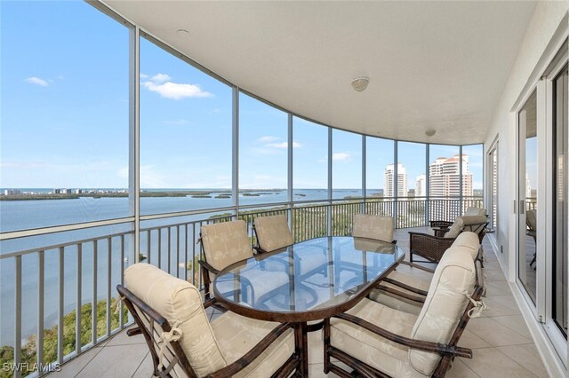 sunroom / solarium with a water view