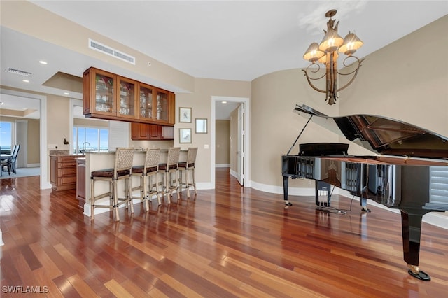 interior space featuring hardwood / wood-style flooring, pendant lighting, and a chandelier