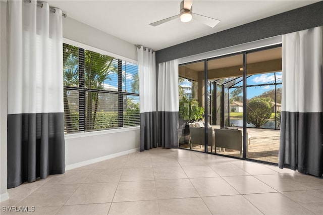 interior space featuring a wealth of natural light, ceiling fan, and light tile patterned floors