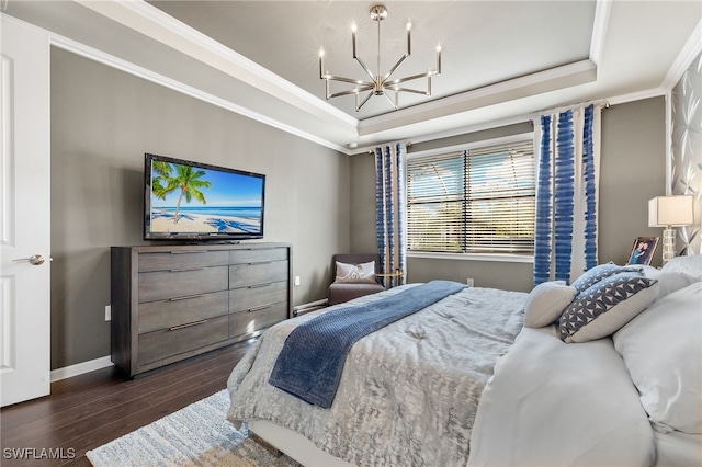 bedroom featuring a tray ceiling, crown molding, dark hardwood / wood-style floors, and an inviting chandelier