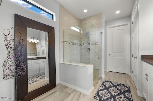 bathroom featuring vanity and a shower with shower door