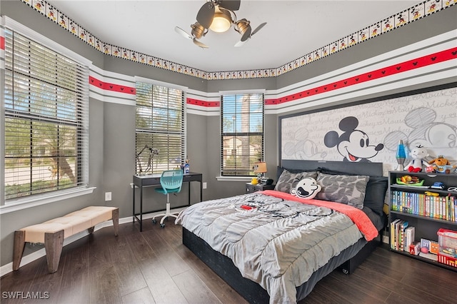 bedroom with multiple windows, ceiling fan, and dark wood-type flooring