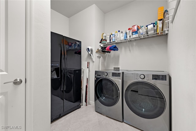 clothes washing area with light tile patterned floors and independent washer and dryer