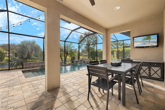 view of patio / terrace featuring pool water feature, glass enclosure, and a swimming pool with hot tub