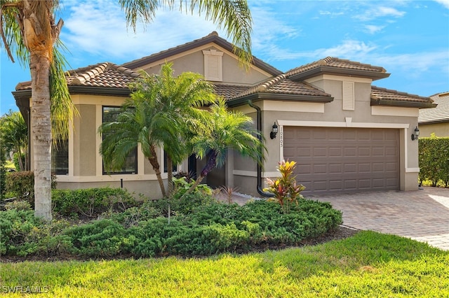 mediterranean / spanish house with a garage