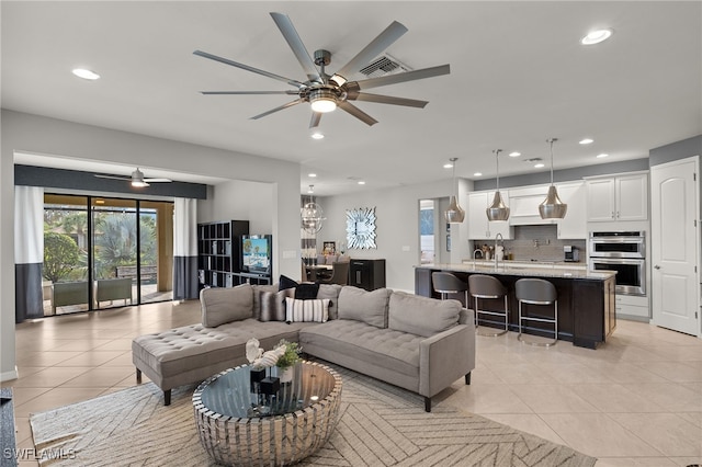 living room with ceiling fan and light tile patterned flooring