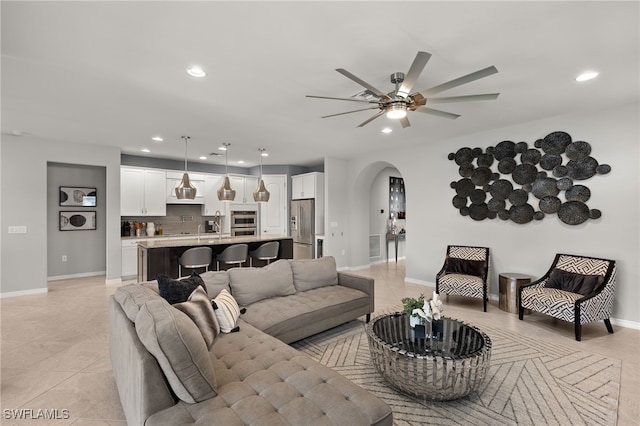 living room featuring ceiling fan and light tile patterned flooring