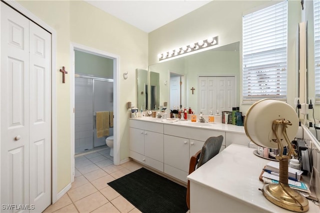 bathroom featuring walk in shower, tile patterned flooring, vanity, and toilet