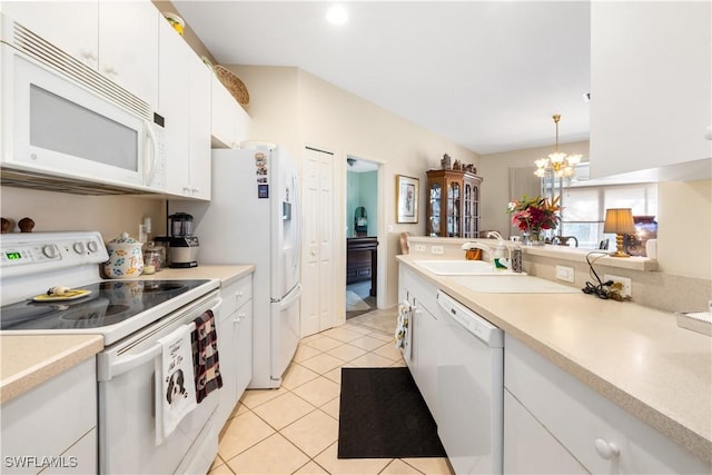 kitchen with white appliances, white cabinets, sink, hanging light fixtures, and light tile patterned floors