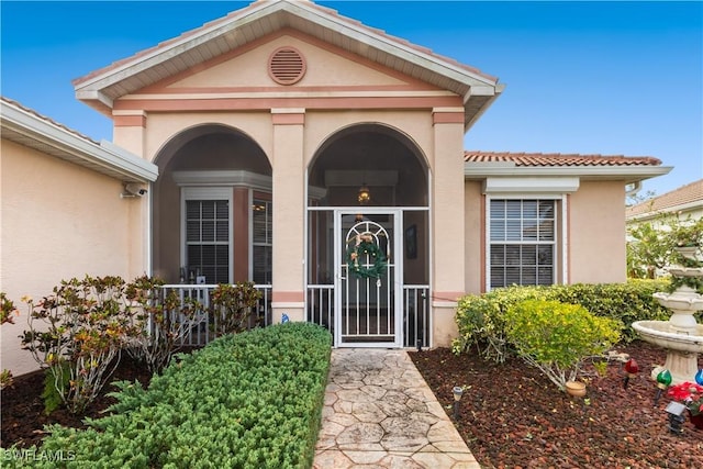 2320 Palo Duro Blvd, North Fort Myers, FL 33917 - doorway to property with stucco siding and a tile roof