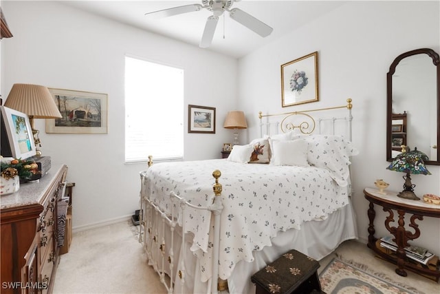 bedroom featuring ceiling fan and light carpet