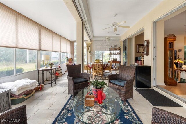 sunroom / solarium with a wealth of natural light and ceiling fan