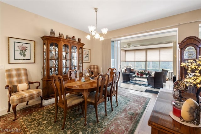 dining area with ceiling fan with notable chandelier