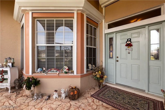 view of exterior entry with covered porch