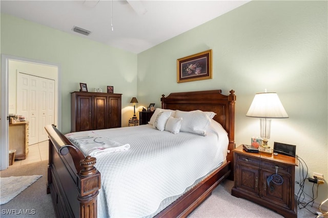 carpeted bedroom with ceiling fan and a closet