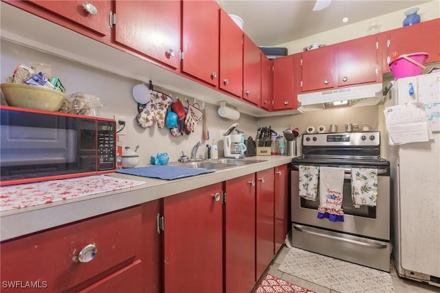 kitchen with stainless steel electric range, white fridge, light tile patterned floors, and sink