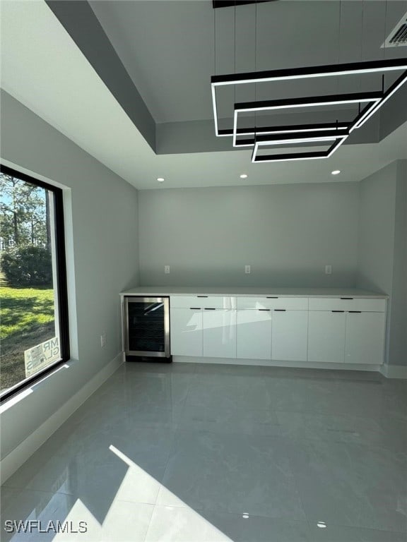 kitchen featuring white cabinets, a wealth of natural light, and wine cooler