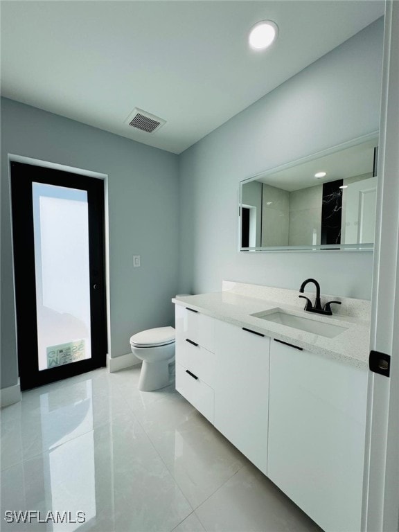 bathroom with vanity and toilet