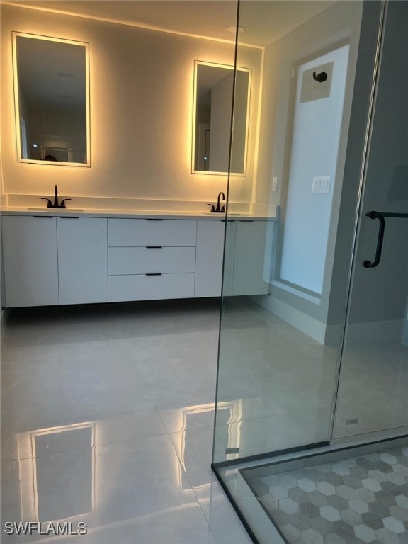 bathroom featuring vanity and an enclosed shower