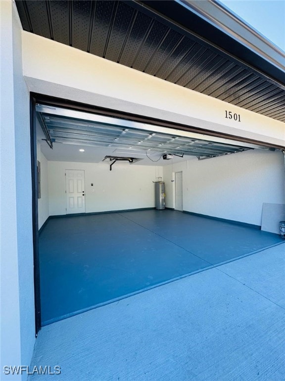 garage featuring electric water heater and a garage door opener