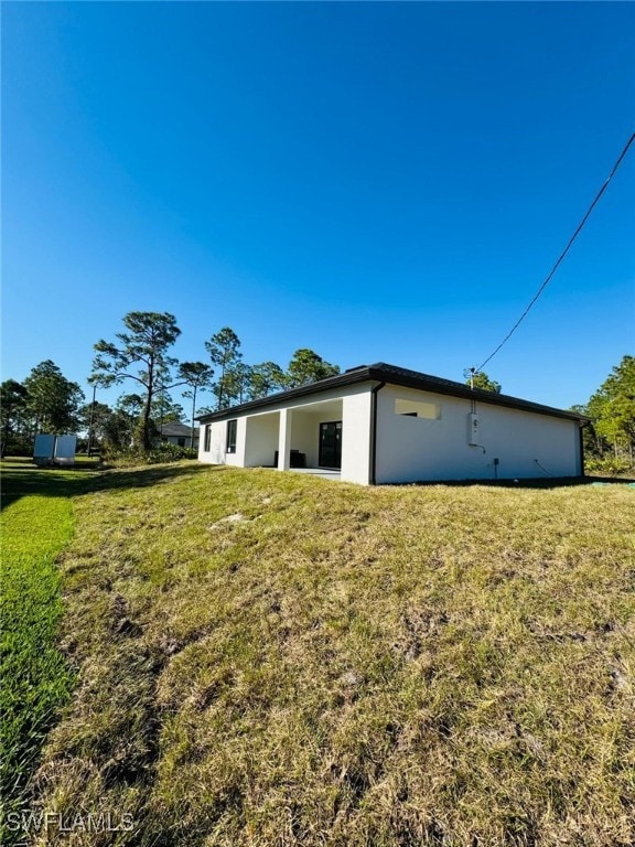 view of side of property with a yard