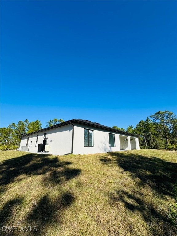 view of side of property with a yard