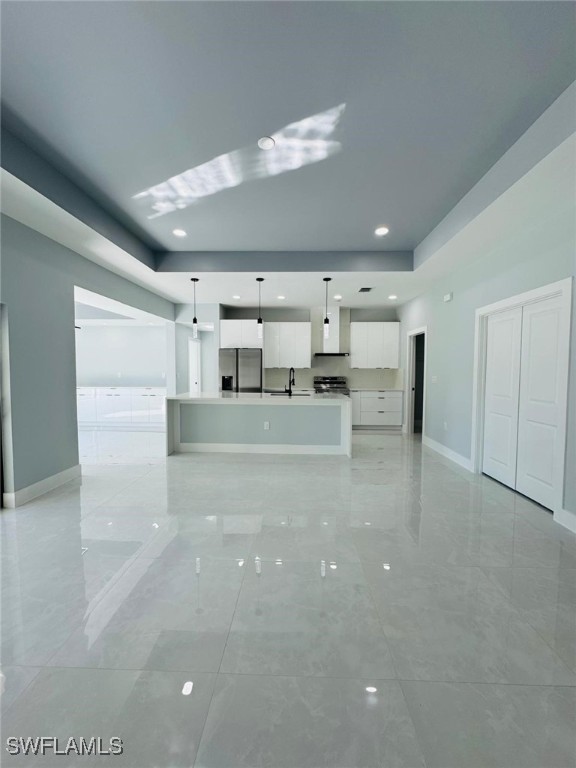 unfurnished living room featuring sink