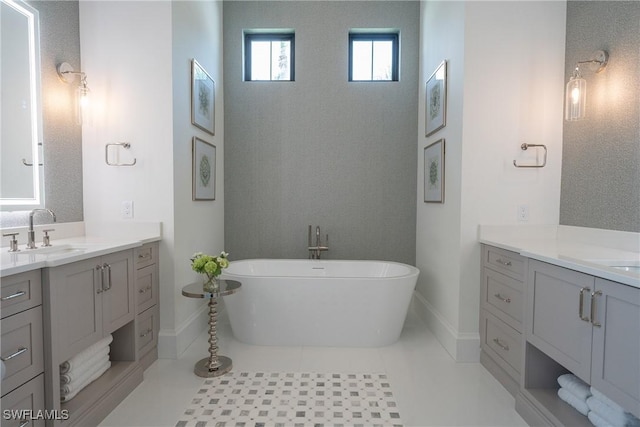 bathroom with tile patterned floors, vanity, and a bath