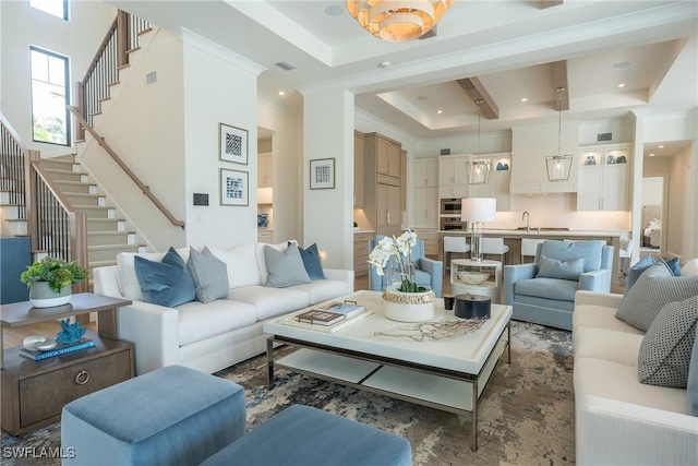 living room featuring beam ceiling, crown molding, and a chandelier