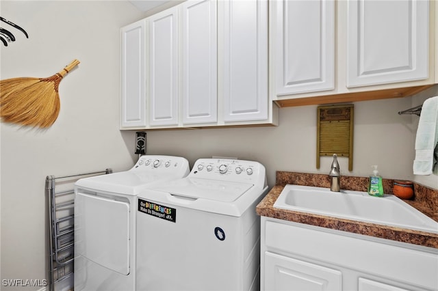 laundry room with sink, cabinets, and independent washer and dryer