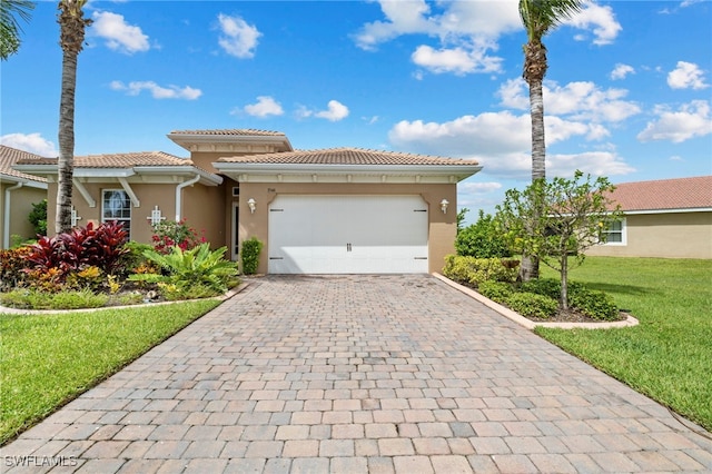 view of front of home with a front yard and a garage