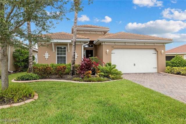 mediterranean / spanish-style home with a front lawn and a garage