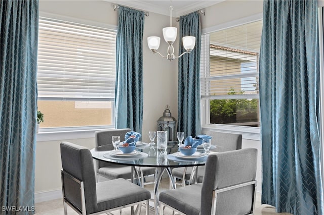 dining room featuring crown molding and an inviting chandelier