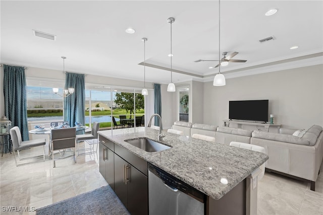 kitchen featuring stainless steel dishwasher, sink, hanging light fixtures, and an island with sink