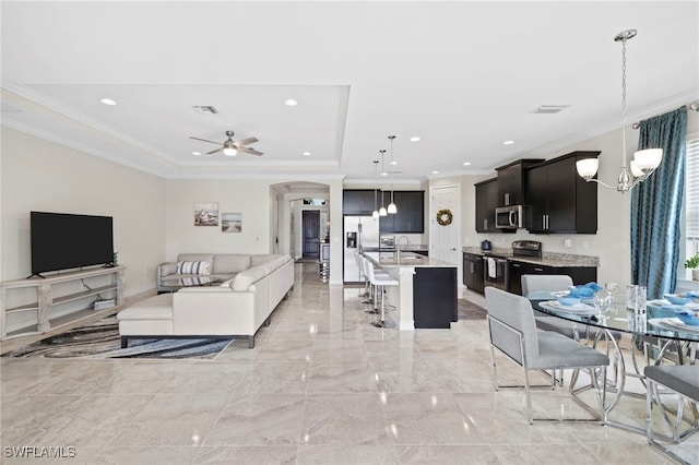 3546 Bridgewell Ct, Fort Myers, FL 33916 - living area featuring marble finish floor, ceiling fan with notable chandelier, crown molding, and arched walkways