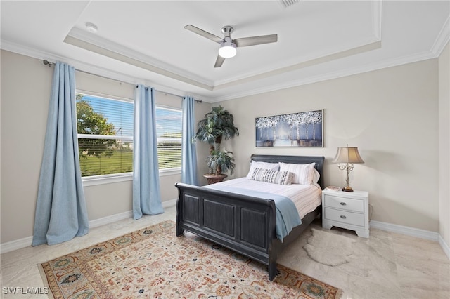 bedroom featuring a tray ceiling, ceiling fan, and ornamental molding